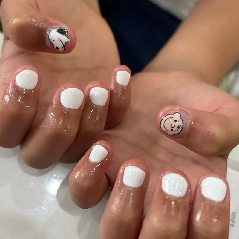White nails with cute character nail art by LENA Nails & Beauty, nail salon in Da Nang