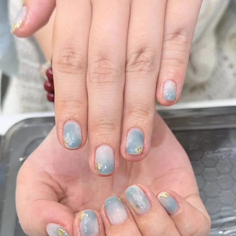 Blue and white marble nails with gold foil by LENA Nails & Beauty, nail salon in Da Nang