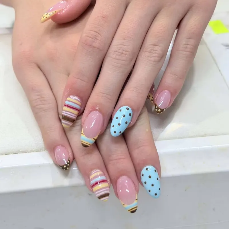 Pastel almond nails with stripes and polka dots by LENA Nails & Beauty, nail salon in Da Nang