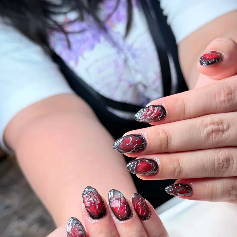 Short nude nails with red and black chrome art by LENA Nails & Beauty, nail salon in Da Nang