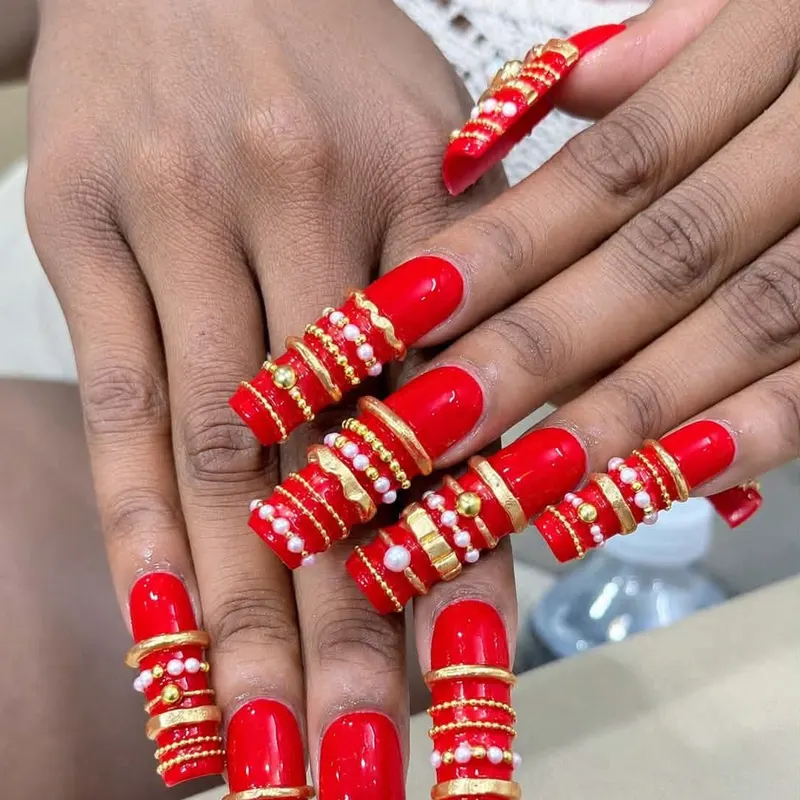 Red coffin nails with gold and pearl 3D art by LENA Nails & Beauty, nail salon in Da Nang