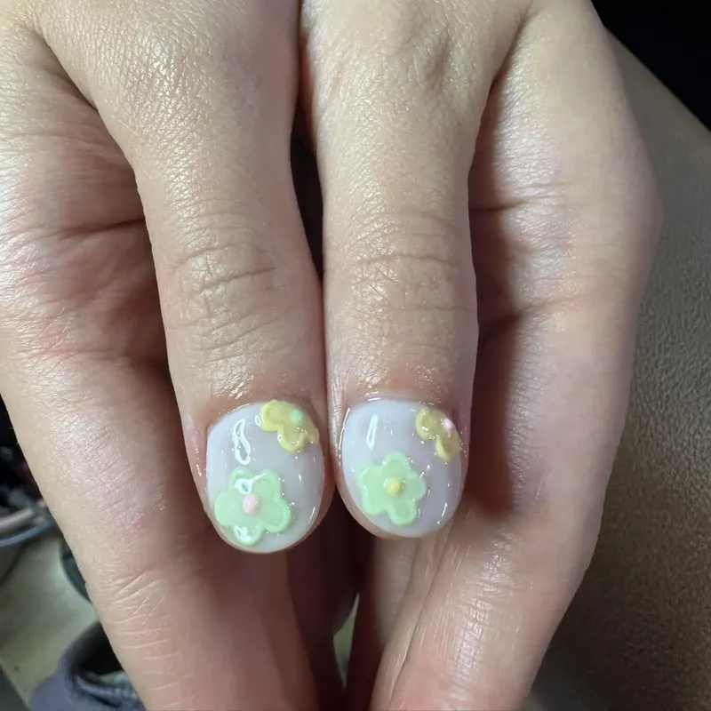 Milky short nails with pastel 3D flowers by LENA Nails & Beauty, nail salon in Da Nang