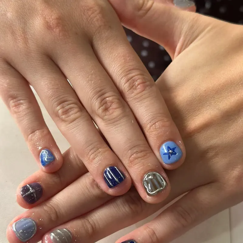 Short nails with navy, chrome and star art by LENA Nails & Beauty, nail salon in Da Nang