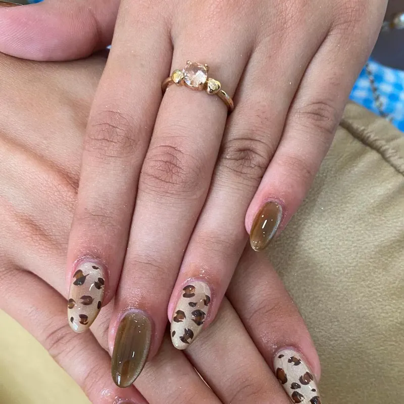 Almond nails with leopard print and brown cat eye by LENA Nails & Beauty, nail salon in Da Nang