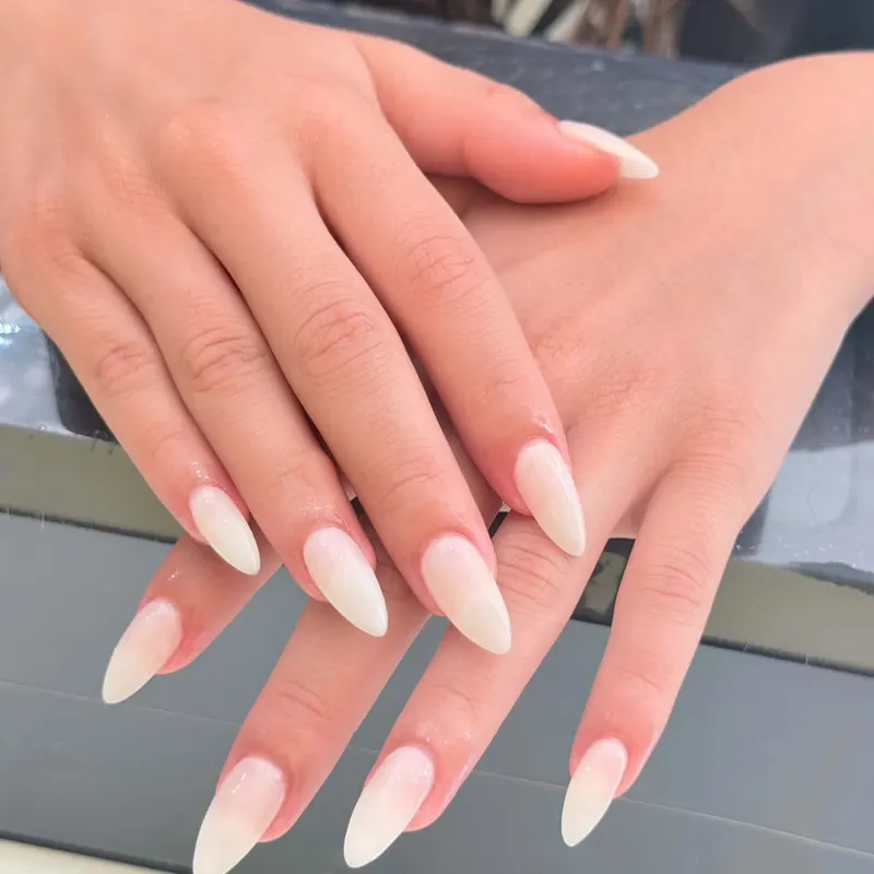 Long almond nails with soft white ombre by LENA Nails & Beauty, nail salon in Da Nang