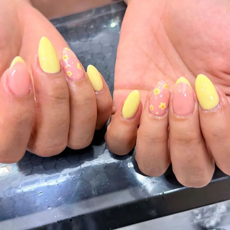 Yellow nails with floral art by LENA Nails & Beauty, nail salon in Da Nang