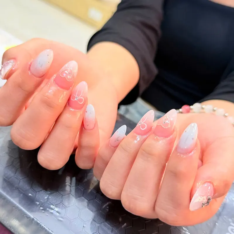 Pink nails with silver bows and glitter by LENA Nails & Beauty, nail salon in Da Nang