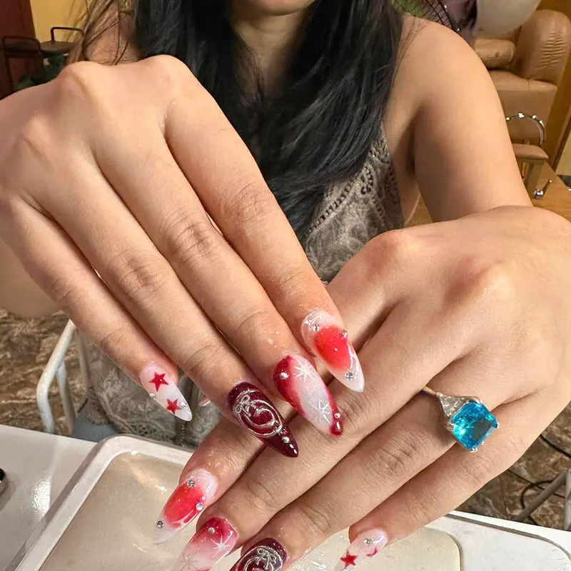 Red rose stiletto nails with star art by LENA Nails & Beauty, nail salon in Da Nang