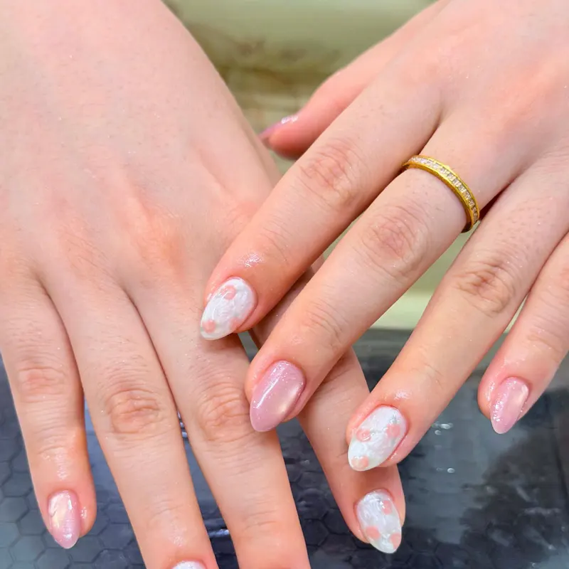 Pink nails with soft white marble floral art by LENA Nails & Beauty, nail salon in Da Nang