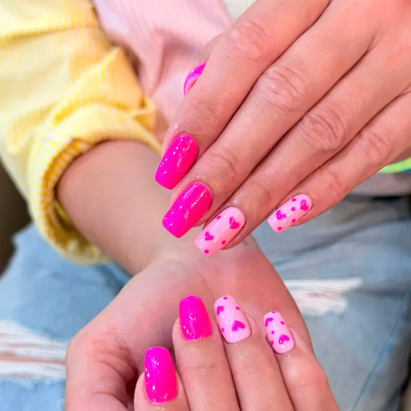 Hot pink nails with pink heart art by LENA Nails & Beauty, nail salon in Da Nang