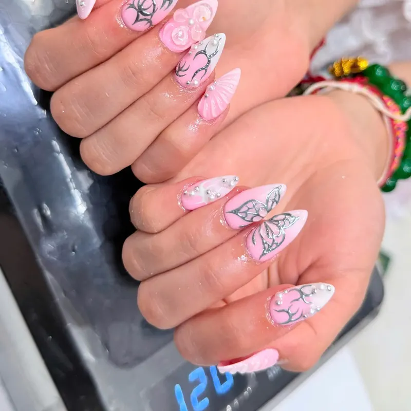 Pink stiletto nails with 3D bows, pearls and rhinestones by LENA Nails & Beauty, nail salon in Da Nang