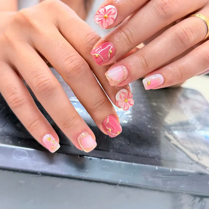Pink French nails with 3D flowers by LENA Nails & Beauty, nail salon in Da Nang