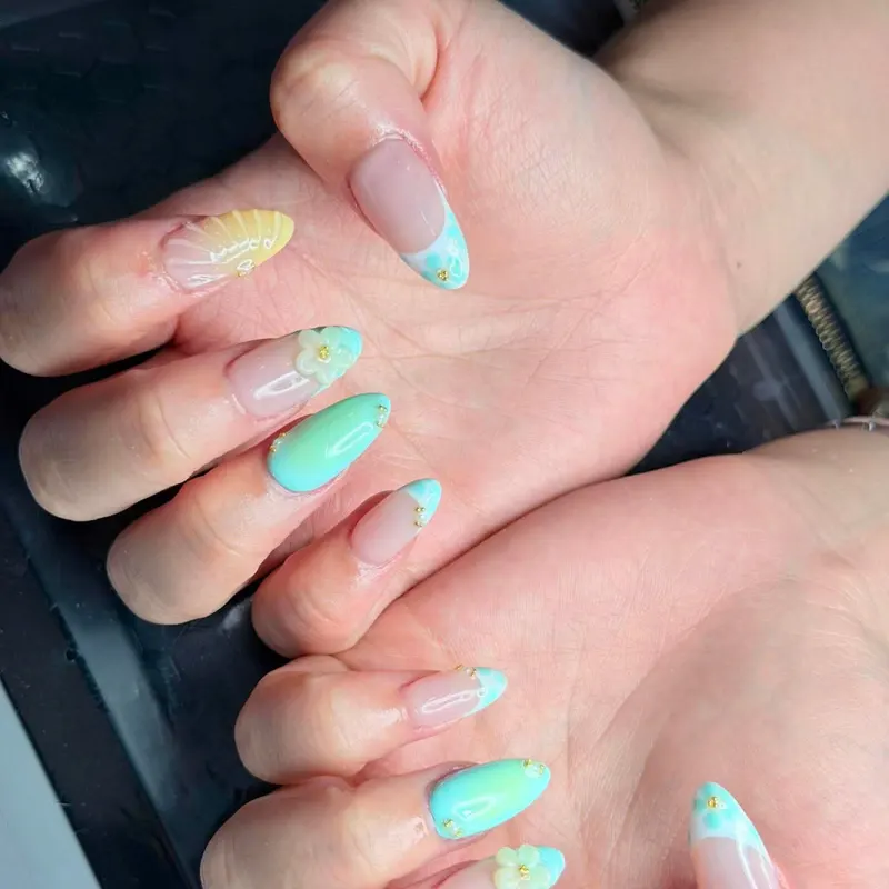 Pastel mint and yellow nails with flower art by LENA Nails & Beauty, nail salon in Da Nang