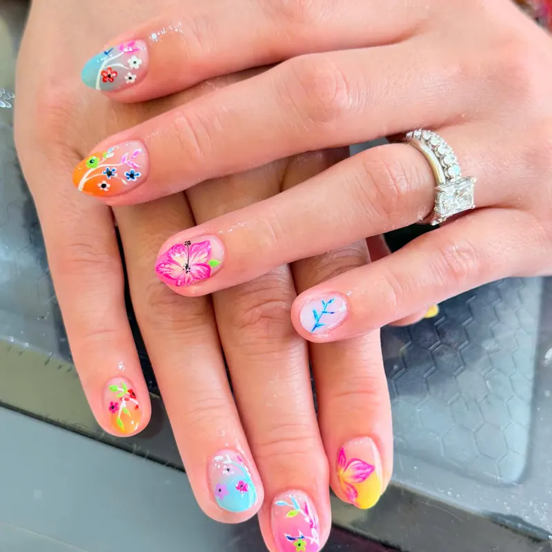 Pink nails with butterfly and flower art by LENA Nails & Beauty, nail salon in Da Nang