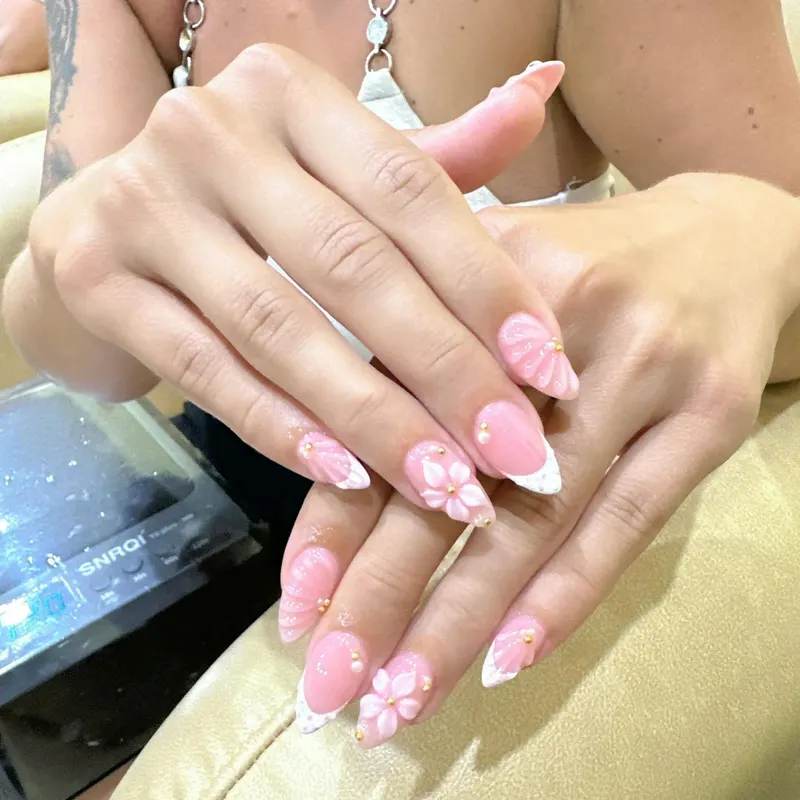Pink nails with 3D white flowers by LENA Nails & Beauty, nail salon in Da Nang