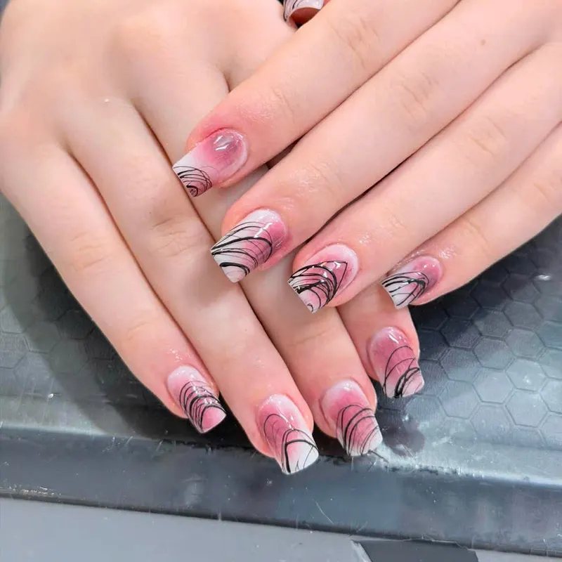 Nude nails with black and white marble swirl art by LENA Nails & Beauty, nail salon in Da Nang